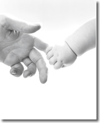 baby holding adults finger